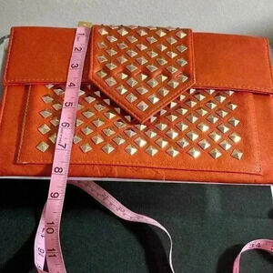MMS orange studded clutch bag